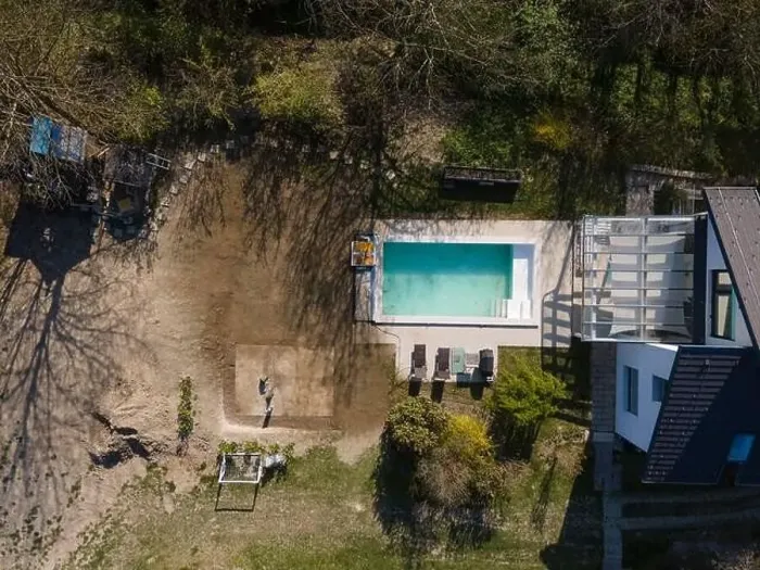 Framed Print : Drone flight over fresh earth area with grass grown next to pool construction site in April Framed Print : Drone flight over fresh earth area with grass grown next to pool construction site in April