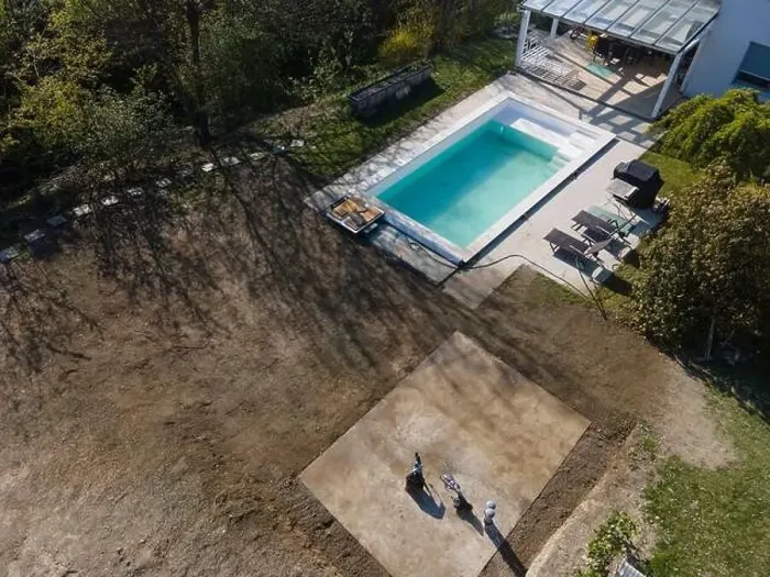 Framed Print : Drone flight over fresh earth area with grass grown next to pool construction site in April Framed Print : Drone flight over fresh earth area with grass grown next to pool construction site in April