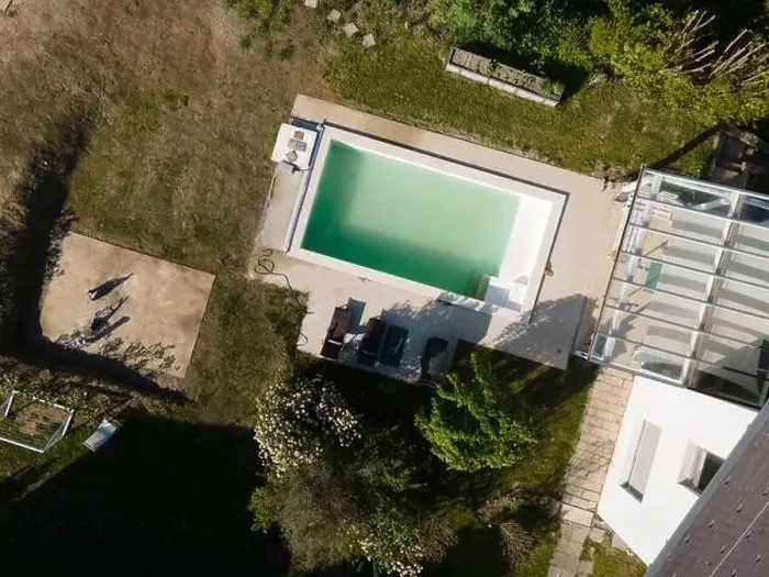 Framed Print : Drone flight over pool in the middle of greenery, fresh grass grown and the pool is not yet cleaned Framed Print : Drone flight over pool in the middle of greenery, fresh grass grown and the pool is not yet cleaned