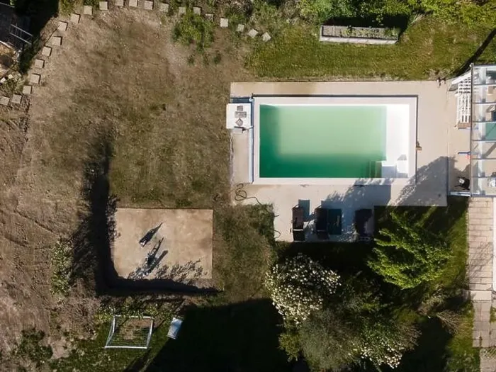 Framed Print : Drone flight over pool in the middle of greenery, fresh grass grown and the pool is not yet cleaned Framed Print : Drone flight over pool in the middle of greenery, fresh grass grown and the pool is not yet cleaned