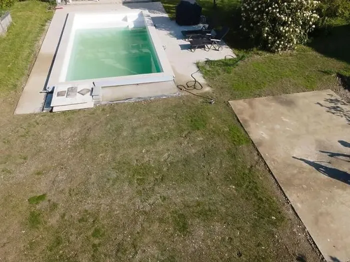 Framed Print : Drone flight over pool in the middle of greenery, fresh grass grown and the pool is not yet cleaned Framed Print : Drone flight over pool in the middle of greenery, fresh grass grown and the pool is not yet cleaned