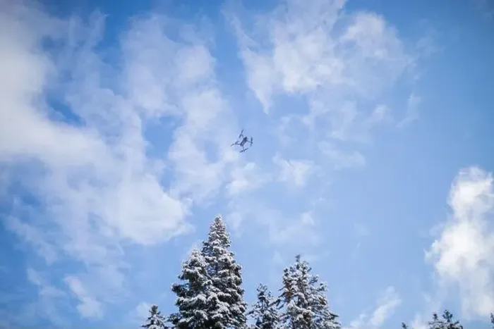 Framed Print : Drone flying over beautiful snowy forest under a blue sky Framed Print : Drone flying over beautiful snowy forest under a blue sky
