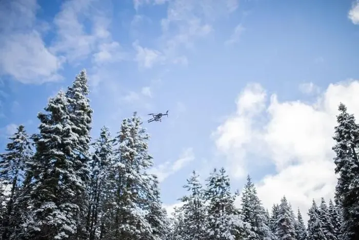 Framed Print : Drone flying over beautiful snowy forest under a blue sky Framed Print : Drone flying over beautiful snowy forest under a blue sky