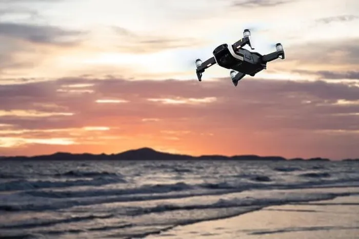Framed Print : Drone flying against the mountain and sea or ocean at sunset sky Framed Print : Drone flying against the mountain and sea or ocean at sunset sky