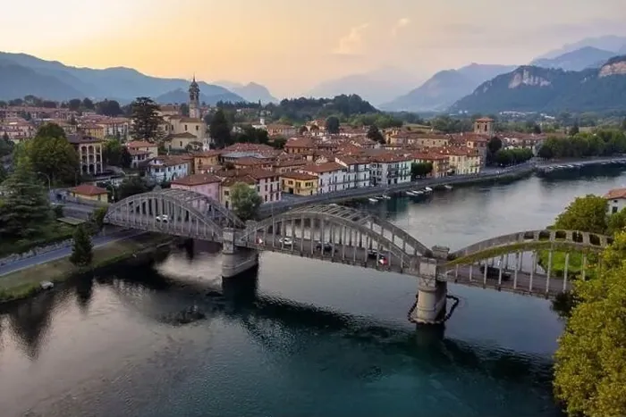 Framed Print : Drone panoramic view Over Bridge And River Towards a characteristic Italian village, Brivio, Lombardy, Italy Framed Print : Drone panoramic view Over Bridge And River Towards a characteristic Italian village, Brivio, Lombardy, Italy