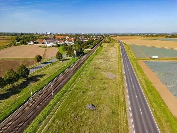 Framed Print : Drone perspective of rural road and railroad line in the countryside, aerial view in Germany Framed Print : Drone perspective of rural road and railroad line in the countryside, aerial view in Germany