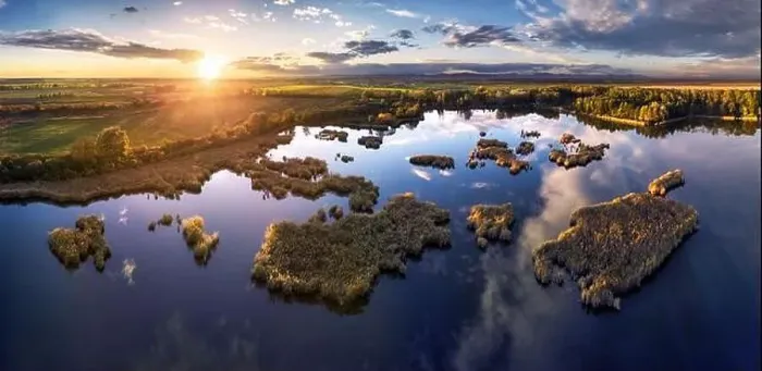 Framed Print : A drone photo of lake - pond bog with sun - Absolutely stunning aerial landscape sunset panorama Framed Print : A drone photo of lake - pond bog with sun - Absolutely stunning aerial landscape sunset panorama