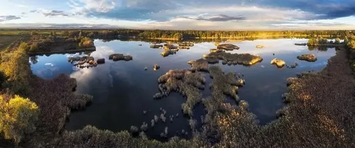 Framed Print : A drone photo of lake - pond bog with sun - Absolutely stunning aerial landscape sunset panorama Framed Print : A drone photo of lake - pond bog with sun - Absolutely stunning aerial landscape sunset panorama