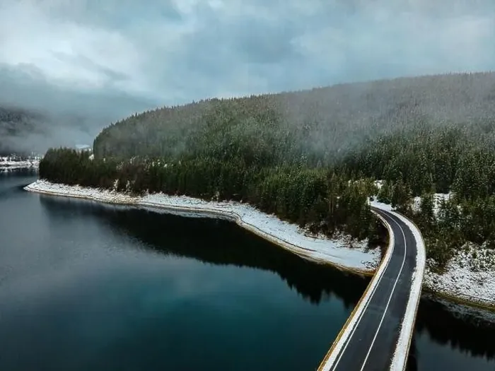 Framed Print : Drone photography from a high altitude of a road and a bridge crossing a mountain lake Framed Print : Drone photography from a high altitude of a road and a bridge crossing a mountain lake
