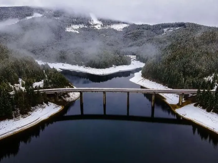 Framed Print : Drone photography from a high altitude of a road and a bridge crossing a mountain lake Framed Print : Drone photography from a high altitude of a road and a bridge crossing a mountain lake