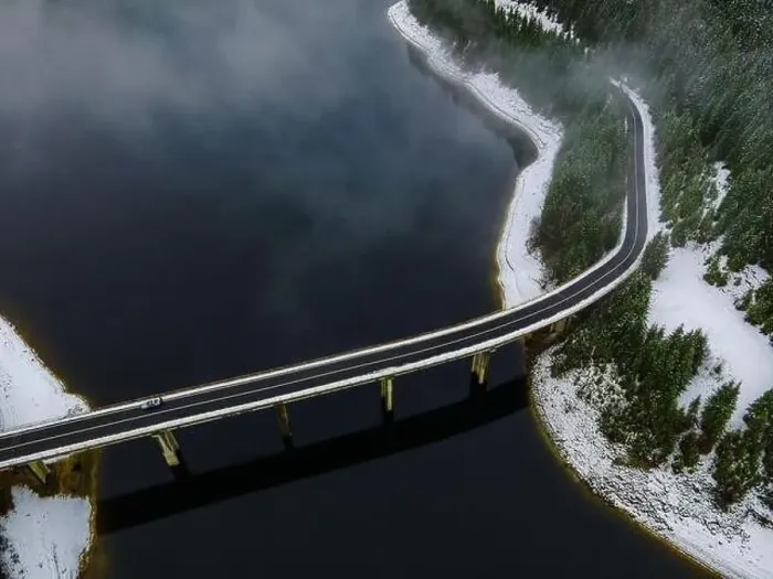 Framed Print : Drone photography from a high altitude of a road and a bridge crossing a mountain lake Framed Print : Drone photography from a high altitude of a road and a bridge crossing a mountain lake