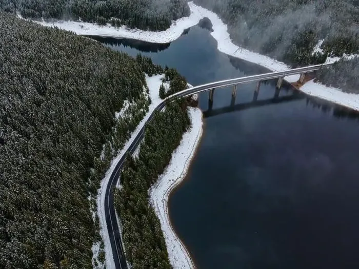 Framed Print : Drone photography from a high altitude of a road and a bridge crossing a mountain lake Framed Print : Drone photography from a high altitude of a road and a bridge crossing a mountain lake