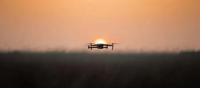 Framed Print : Drone quadcopter with digital camera in flight at sunset, Silhouette of drone at sunset Framed Print : Drone quadcopter with digital camera in flight at sunset, Silhouette of drone at sunset