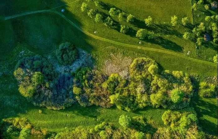 Framed Print : Drone shot at a green countrysided path through grassy meadows, where you can enjoy a healthy walk at the fresh air Framed Print : Drone shot at a green countrysided path through grassy meadows, where you can enjoy a healthy walk at the fresh air