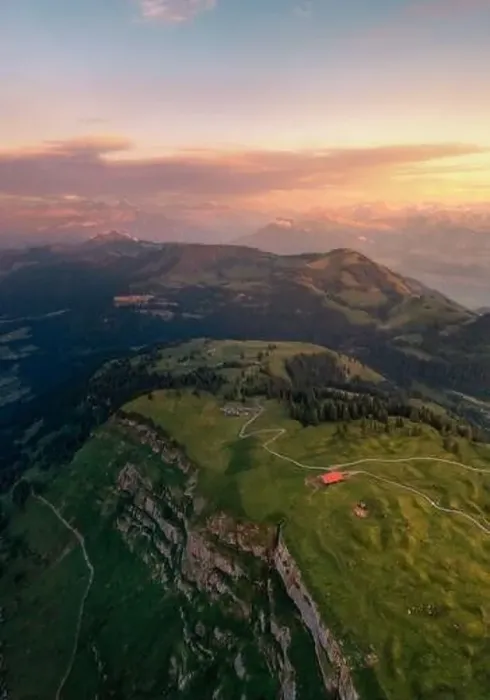 Framed Print : a drone shot on top of a mountain in the distance you can see the alps
