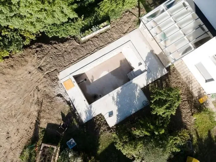 Framed Print : Drone shot of pool construction site in a garden, earth around the pool is already backfilled Framed Print : Drone shot of pool construction site in a garden, earth around the pool is already backfilled