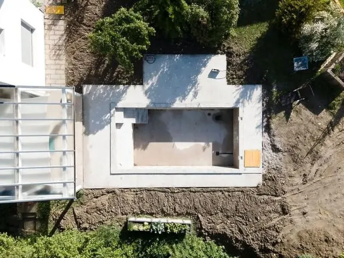 Framed Print : Drone shot of pool construction site in a garden, earth around the pool is already backfilled