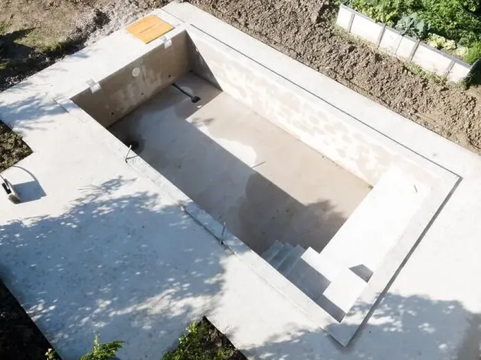 Framed Print : Drone shot of pool construction site in a garden, earth around the pool is already backfilled