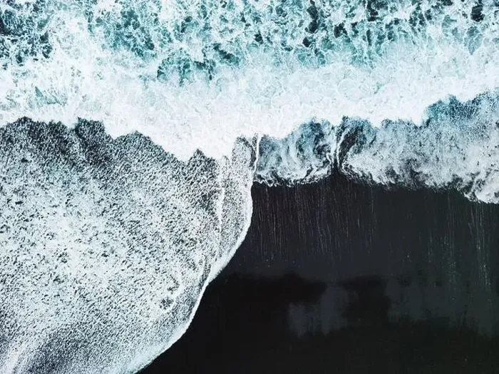 Framed Print : Drone shot waves crashing on the black sand beach Framed Print : Drone shot waves crashing on the black sand beach