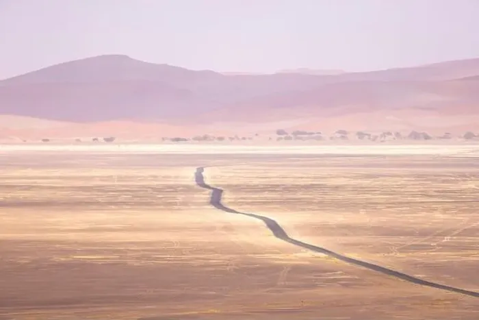 Framed Print : Drone view of arid land with hills and lonely route running through desert Framed Print : Drone view of arid land with hills and lonely route running through desert