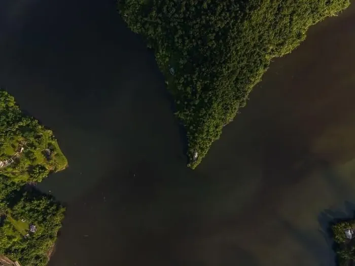 Framed Print : Drone view of calm winding lake streaming through hilly valley covered with dense forest Framed Print : Drone view of calm winding lake streaming through hilly valley covered with dense forest
