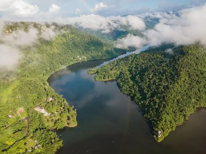 Framed Print : Drone view of calm winding lake streaming through hilly valley covered with dense forest and clouds