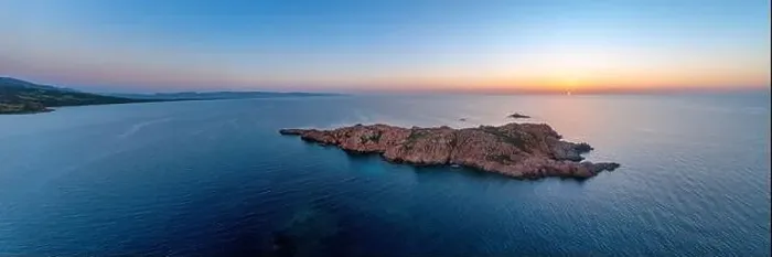 Framed Print : From above drone view of Castelsardo's rugged coastline at sunset with serene waters Framed Print : From above drone view of Castelsardo's rugged coastline at sunset with serene waters