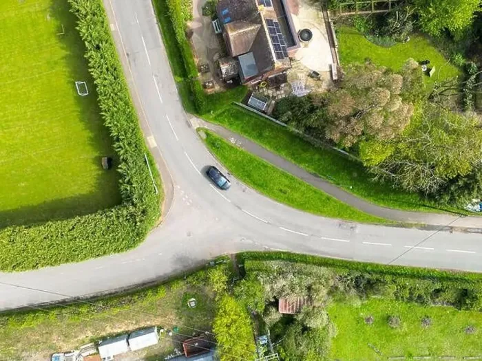 Framed Print : Drone top down view of a dangerous bend and road junction in rural England Framed Print : Drone top down view of a dangerous bend and road junction in rural England