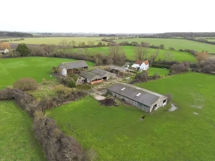 Framed Print : Drone view of a derelict dairy farm showing the cow sheds and grain hopper. The white farm building is still in use Framed Print : Drone view of a derelict dairy farm showing the cow sheds and grain hopper. The white farm building is still in use
