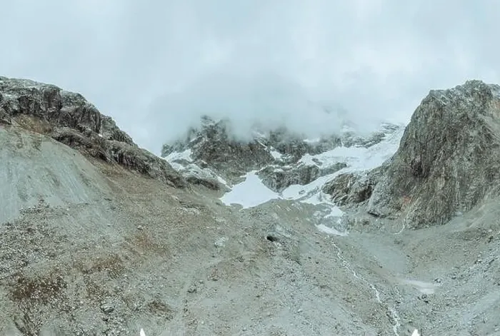 Framed Print : drone view over a desolate receding alpine glacier surrounded by mountains and snow covered rocks and peaks Framed Print : drone view over a desolate receding alpine glacier surrounded by mountains and snow covered rocks and peaks