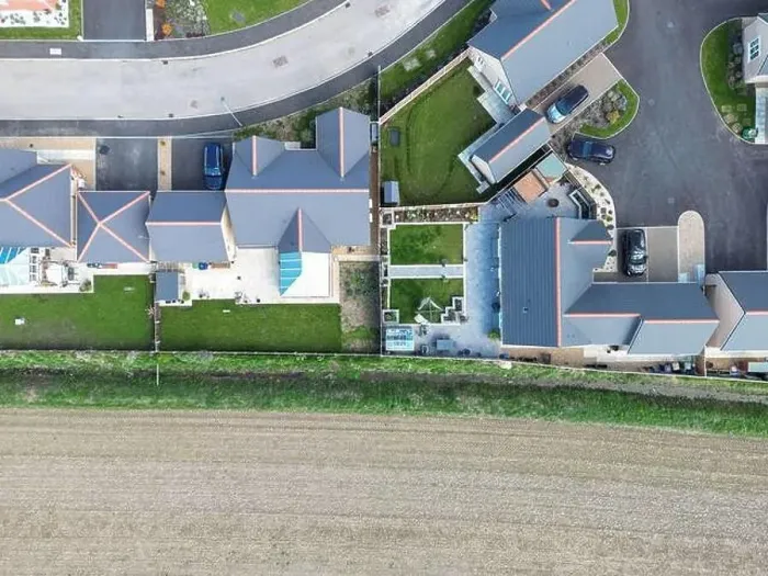 Framed Print : Drone top down view of detached bungalows seen at a new housing development in the English countryside Framed Print : Drone top down view of detached bungalows seen at a new housing development in the English countryside