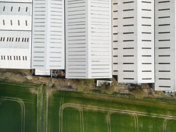 Framed Print : Drone top down view of a large warehouse facility seen at the edge of an arable field in a rural English location Framed Print : Drone top down view of a large warehouse facility seen at the edge of an arable field in a rural English location