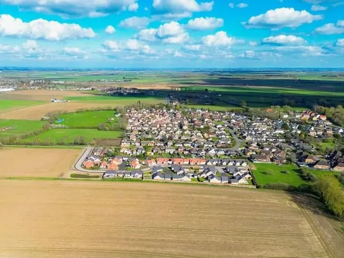Framed Print : Drone view of a new housing estate showing detached bungalows in a rural location in Cambridgeshire, UK