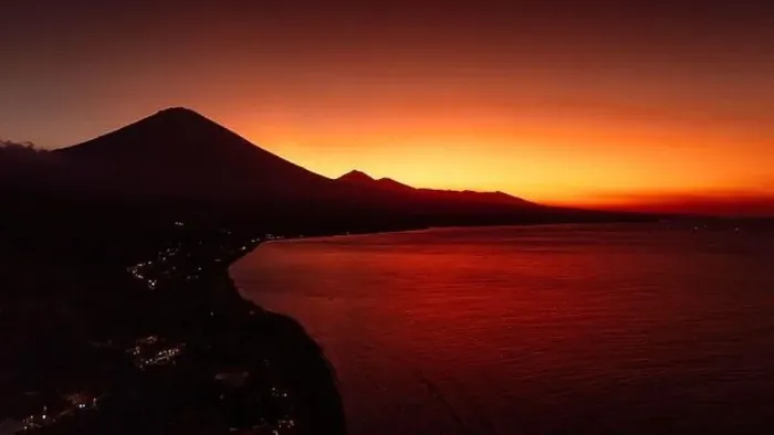 Framed Print : Drone view panorama of coastline with silhouette of volcano and sunset with quiet sea in Bali Framed Print : Drone view panorama of coastline with silhouette of volcano and sunset with quiet sea in Bali