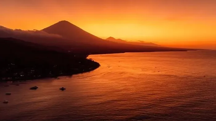 Framed Print : Drone view panorama of coastline with silhouette of volcano and sunset with quiet sea in Bali Framed Print : Drone view panorama of coastline with silhouette of volcano and sunset with quiet sea in Bali