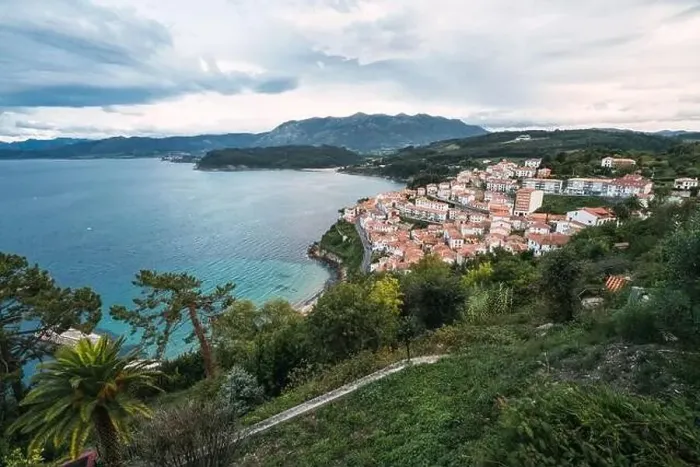 Framed Print : Drone view of peaceful seashore with green trees and small town with red roofs locating near blue sea Framed Print : Drone view of peaceful seashore with green trees and small town with red roofs locating near blue sea