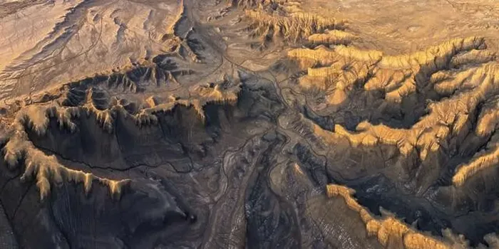 Framed Print : From above drone view of picturesque scenery with rough rocky formations and dry land in North Caineville Mesa Framed Print : From above drone view of picturesque scenery with rough rocky formations and dry land in North Caineville Mesa