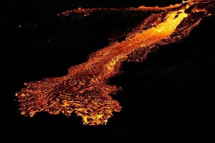 Framed Print : Drone view of stream of hot orange lava flowing through mountainous terrain in morning in Iceland Framed Print : Drone view of stream of hot orange lava flowing through mountainous terrain in morning in Iceland