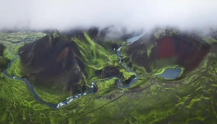 Framed Print : From above drone view of volcanic lakes and rivers located on green mountainous terrain on cloudy day in Iceland
