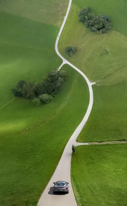 Framed Print : Droneception shot ofs curve street in countryside bending up in front of silver car Framed Print : Droneception shot ofs curve street in countryside bending up in front of silver car