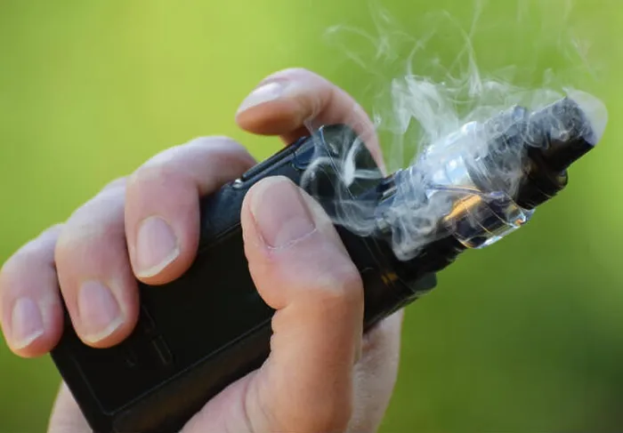 Framed Print : An E Cigarette / Mod in the hand of a man vaping close up photo Framed Print : An E Cigarette / Mod in the hand of a man vaping close up photo