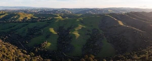 Early morning light shines on the rolling hills in the East Bay region near San Francisco Bay, California. This area turns green during winter months