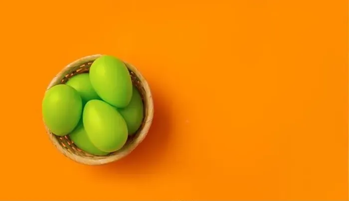 Framed Print : Easter concept. Simple composition with green eggs in basket on vibrant orange background Framed Print : Easter concept. Simple composition with green eggs in basket on vibrant orange background
