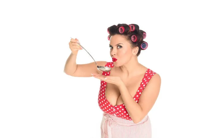Framed Print : emotional plus size housewife cooking with ladle looking at camera isolated on white