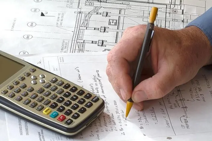 Framed Print : Engineer doing hand calculations on a calculation sheet, with a calculator on the side Framed Print : Engineer doing hand calculations on a calculation sheet, with a calculator on the side