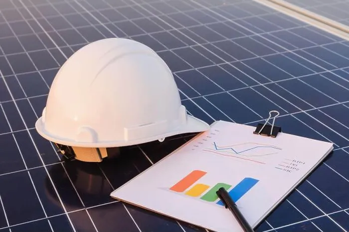 Framed Print : Engineers are examining the performance graph of energy production from solar panels that are alternative energy
