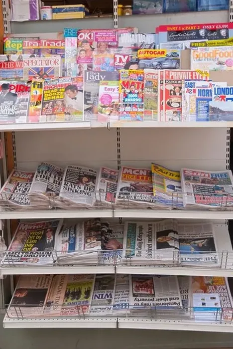 Framed Print : English Newspapers and glossy magazines on a shelf for sale in a Uk newsagents shop store Framed Print : English Newspapers and glossy magazines on a shelf for sale in a Uk newsagents shop store