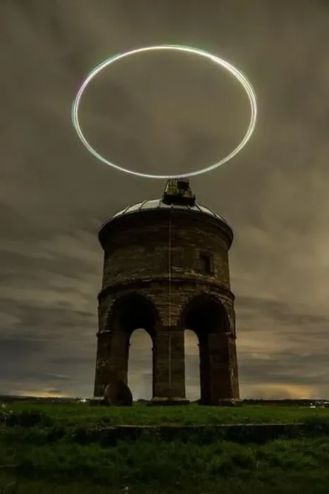 Framed Print : Enigmatic night view of an ancient windmill with a drone light trail creating a halo effect in the dark sky Framed Print : Enigmatic night view of an ancient windmill with a drone light trail creating a halo effect in the dark sky