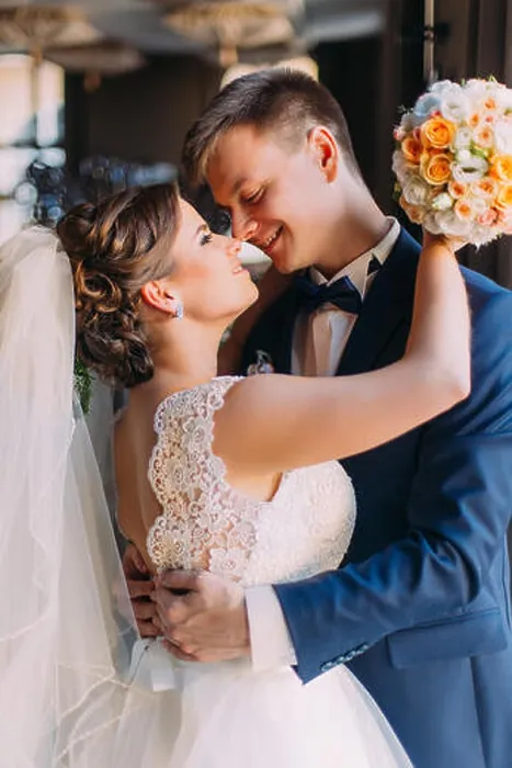 Framed Print : Enloved wedding couple. Beautiful bride with bouquet and handsome groom standing indoors Framed Print : Enloved wedding couple. Beautiful bride with bouquet and handsome groom standing indoors