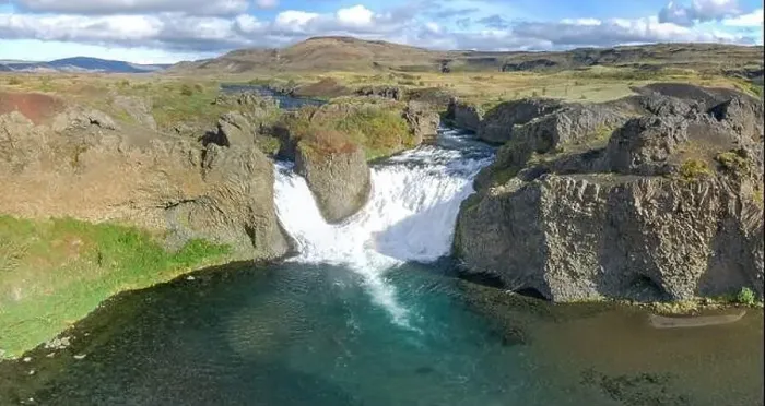 Framed Print : Epic aerial drone view flying over landscape of Hjalparfoss waterfall and lagoon on a sunny day Framed Print : Epic aerial drone view flying over landscape of Hjalparfoss waterfall and lagoon on a sunny day